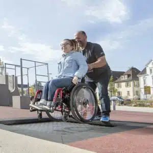 jeune fille en fauteuil roulant jouant sur un trampoline