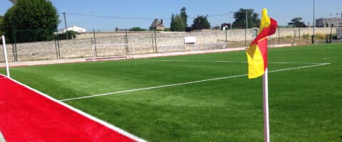 Corner d'un terrain de football en gazon synthétique avec drapeau